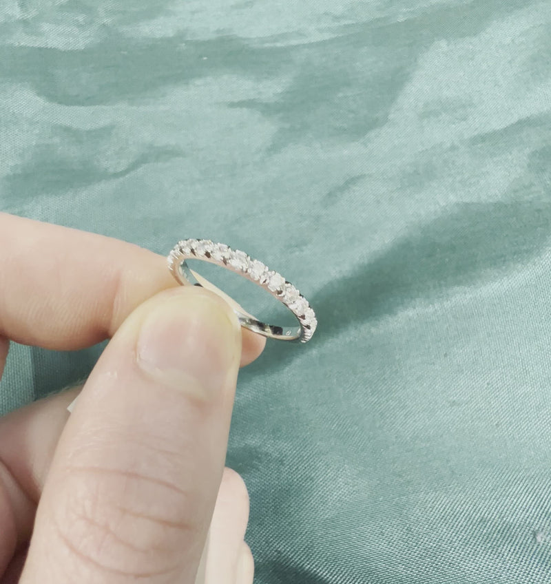 Hand holding diamond anniversary ring with French setting