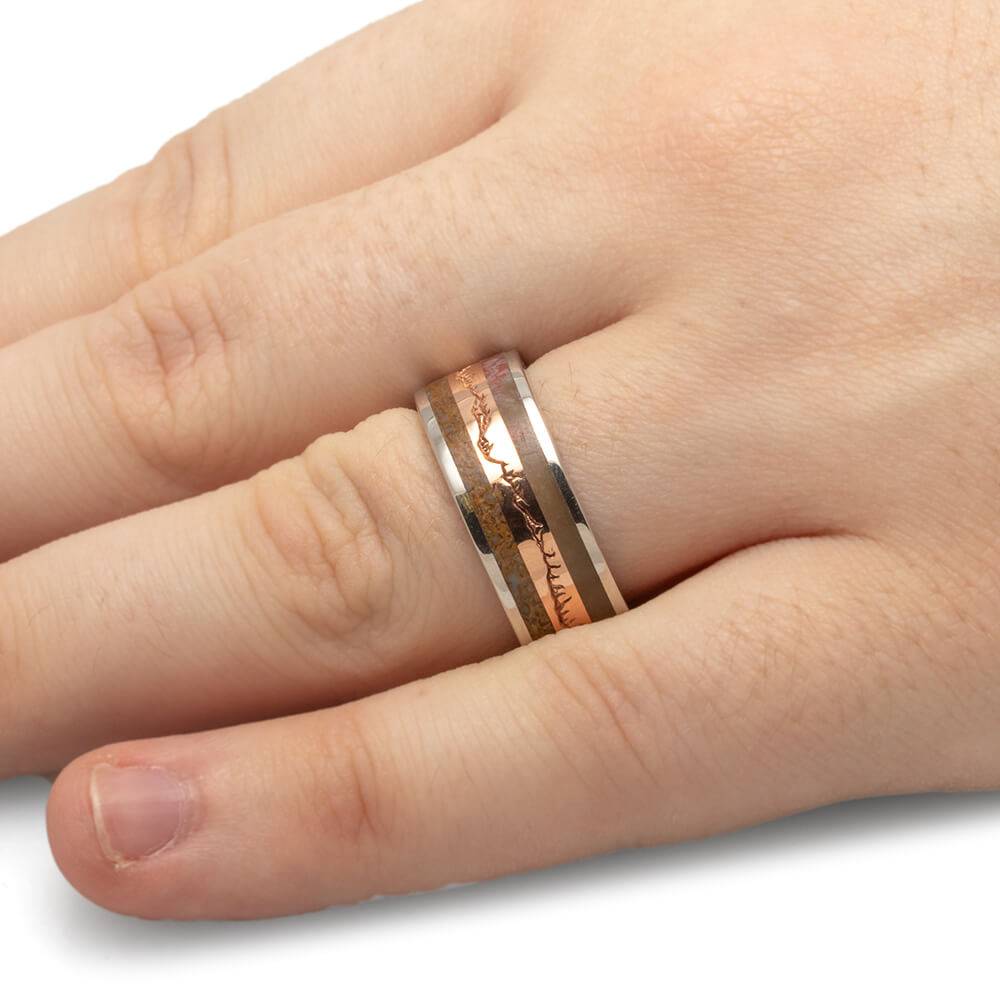 Fossilized wood and bone wedding band worn on hand