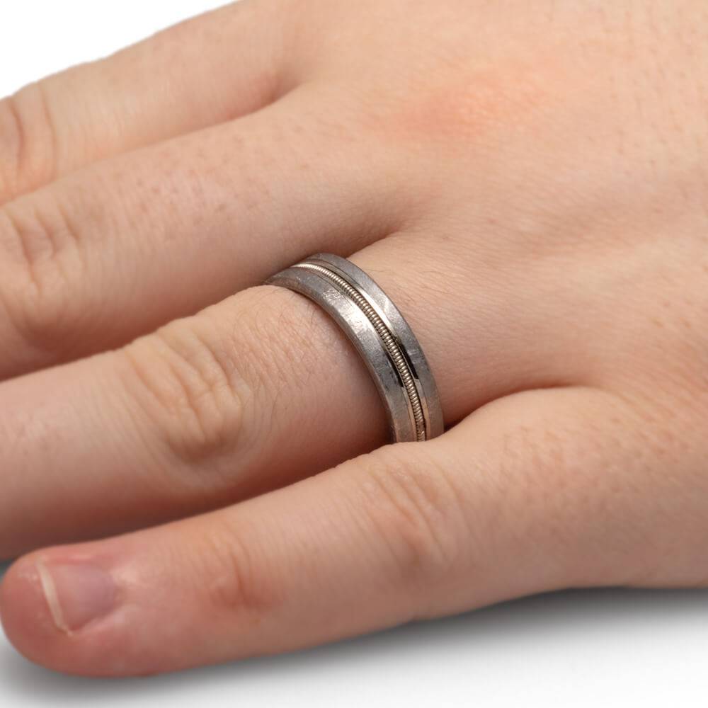 Meteorite and Guitar String Ring on Hand