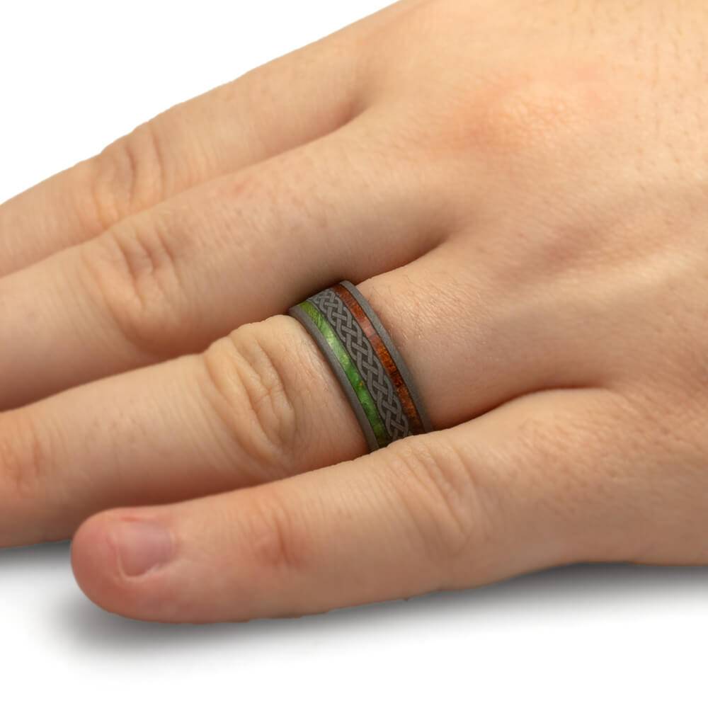 Celtic wedding band on hand, featuring wood and green inlay