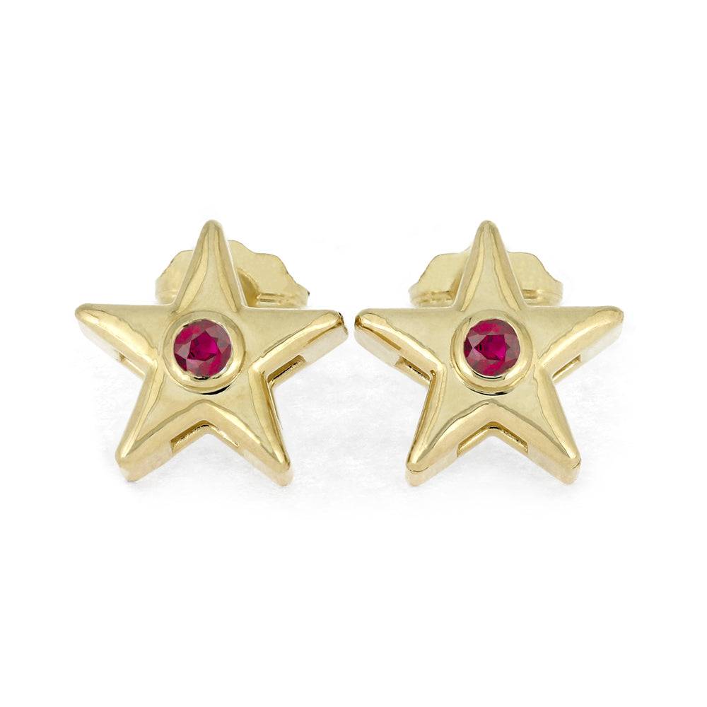 Gold star stud earrings with red birthstone on white background