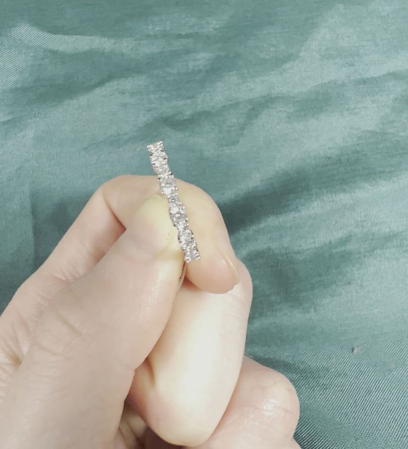 Hand holding diamond half eternity anniversary band