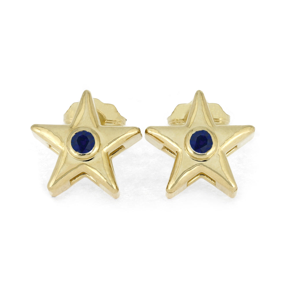 Gold star stud earrings with blue birthstone on white background