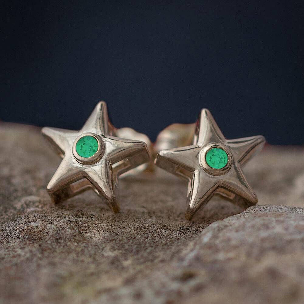 Gold star stud earrings with green birthstone