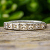 Square cut diamond anniversary band with bezel setting outdoors