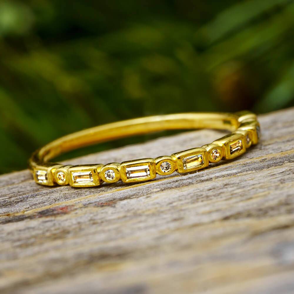 Yellow gold diamond anniversary band with baguette and round cuts