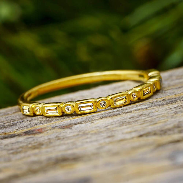 Yellow gold diamond anniversary band with baguette and round cuts