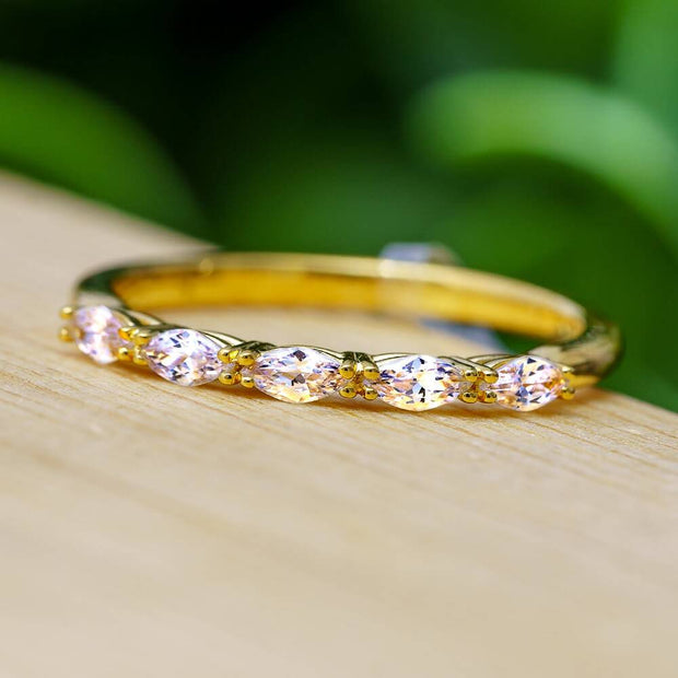 Marquise cut diamond wedding band on wood surface