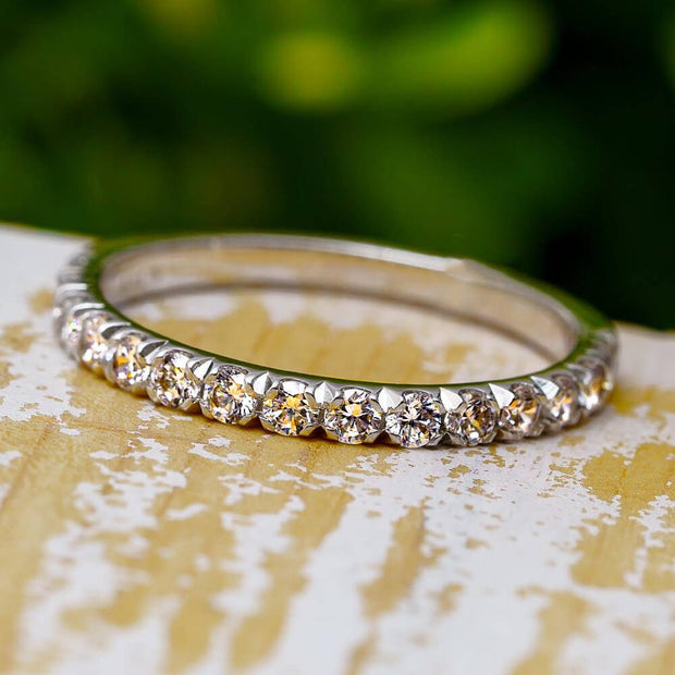 Diamond anniversary ring with French setting on wood