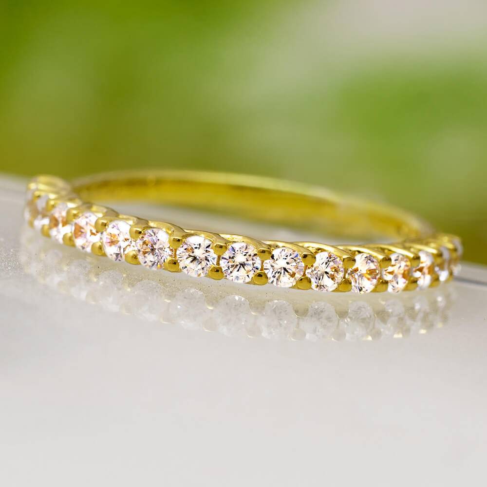 Yellow gold diamond wedding band with shared prong setting