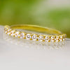 Yellow gold diamond wedding band with shared prong setting