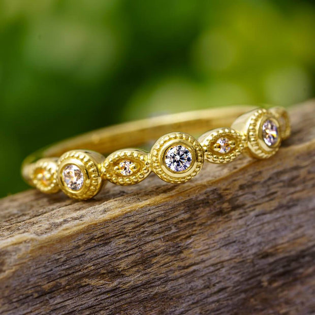 Vintage style diamond band with bezel settings on wood