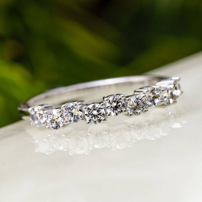 Round anniversary band with asymmetrical diamond design