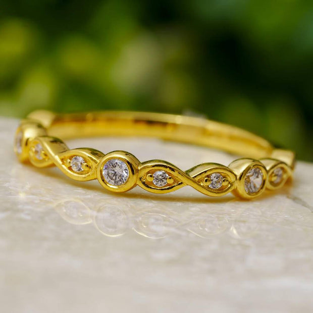 Gold anniversary band with diamonds and infinity symbols