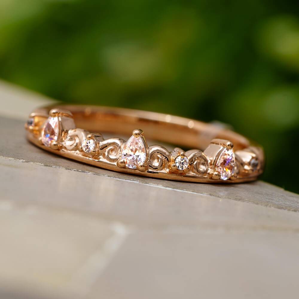 Rose gold band with pear cut diamonds on display