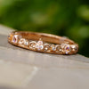 Rose gold band with pear cut diamonds on display