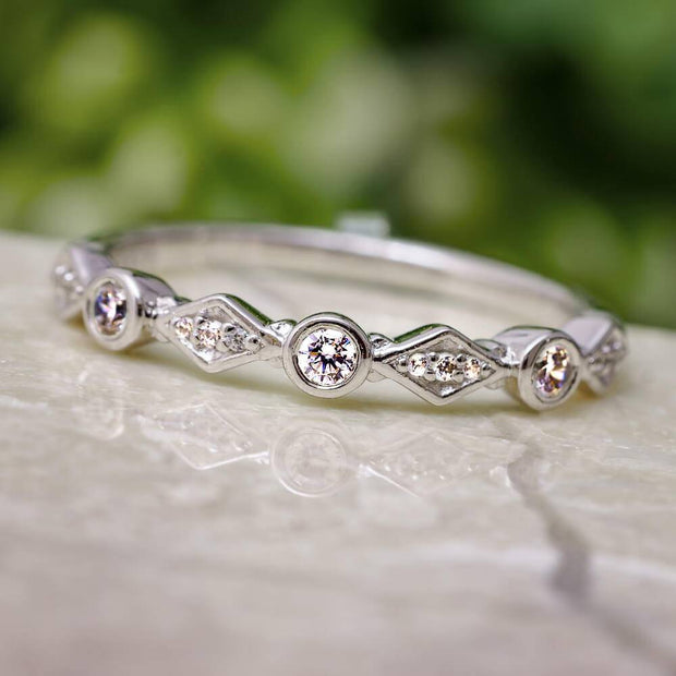 Diamond stackable band with circles and diamonds on marble