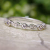 Diamond stackable band with circles and diamonds on marble