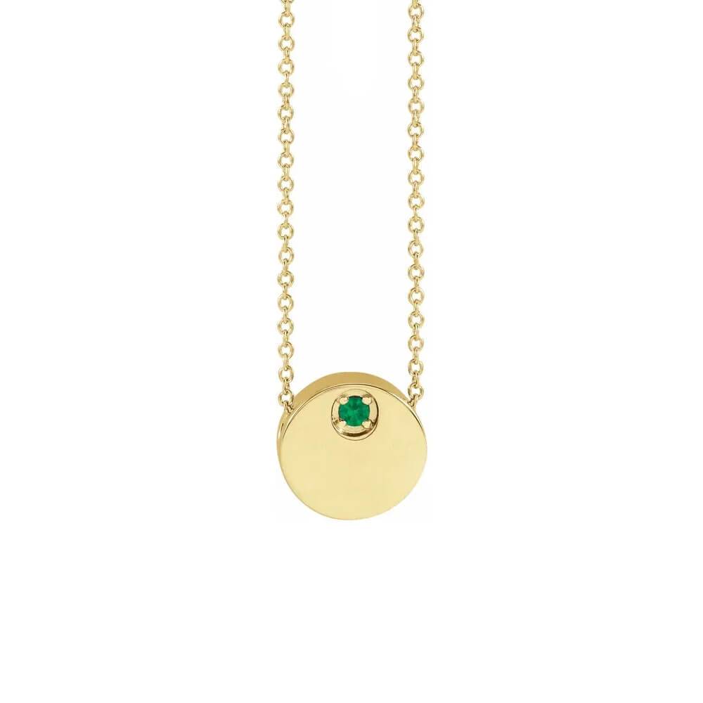 Gold circle necklace with emerald pendant