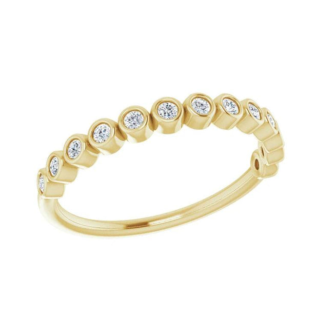 Side view of bezel set diamond anniversary band in yellow gold