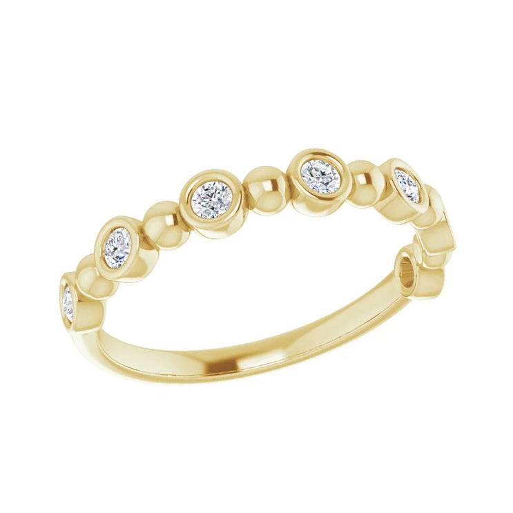 Elegant gold anniversary ring with bezel set diamonds