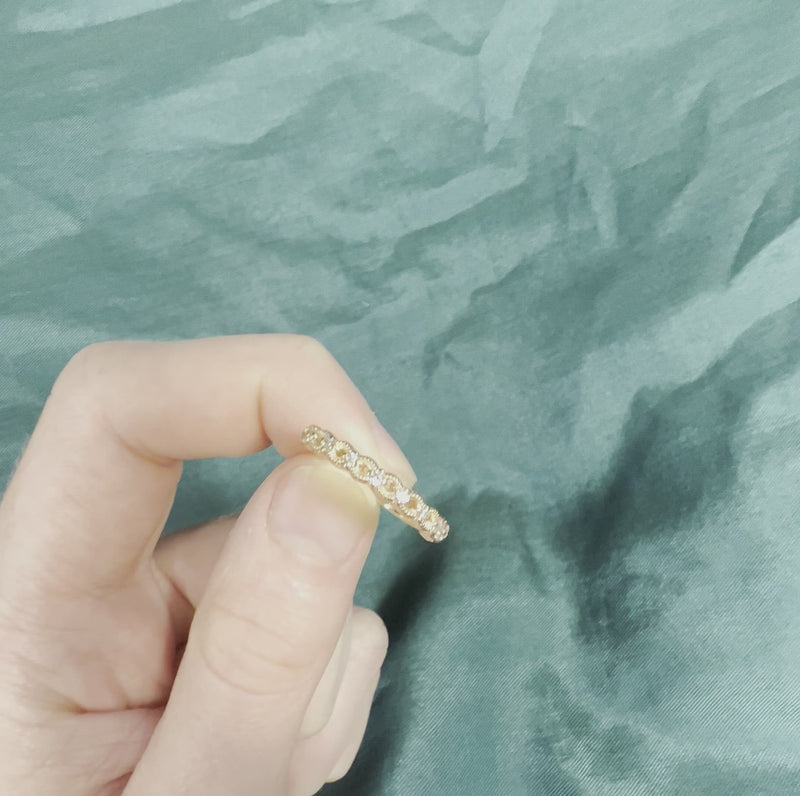 Hand holding rose gold diamond anniversary band