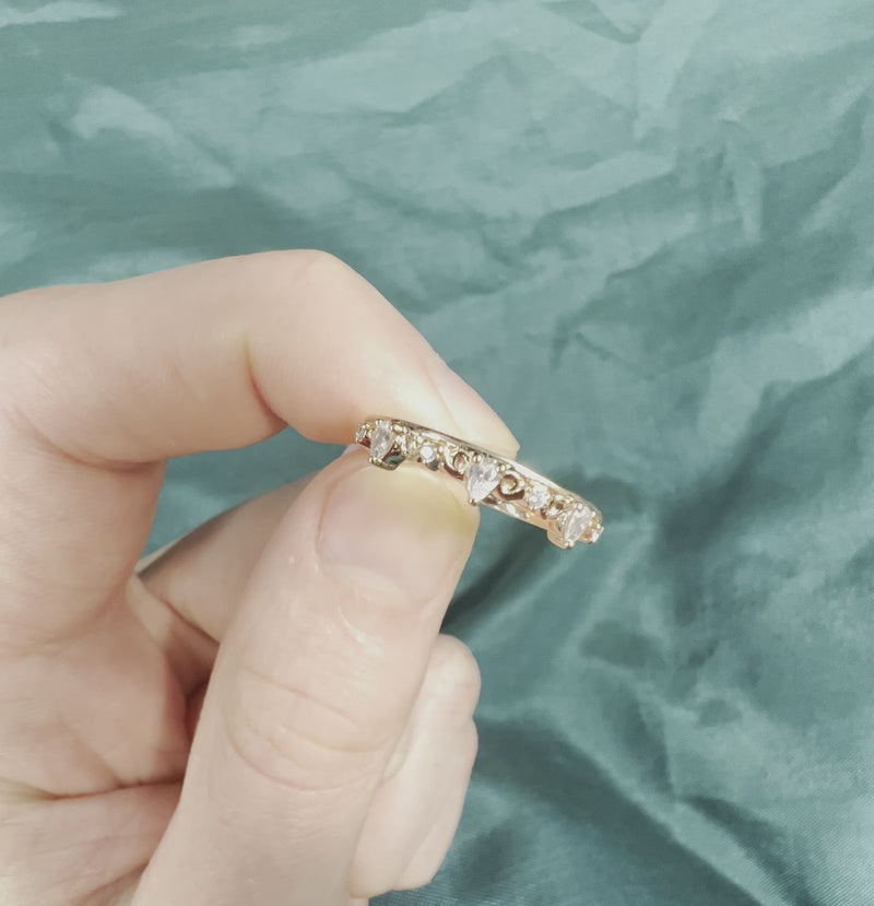 Hand holding a rose gold diamond ring