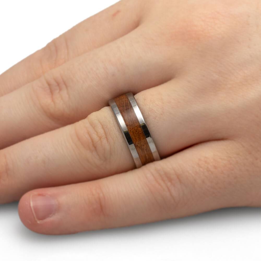 Men's wedding band on hand, tungsten and oak wood